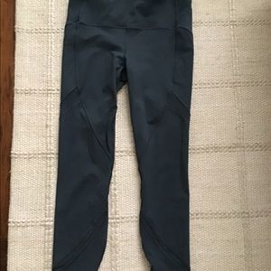 Dark green Lululemon leggings with leg detail.